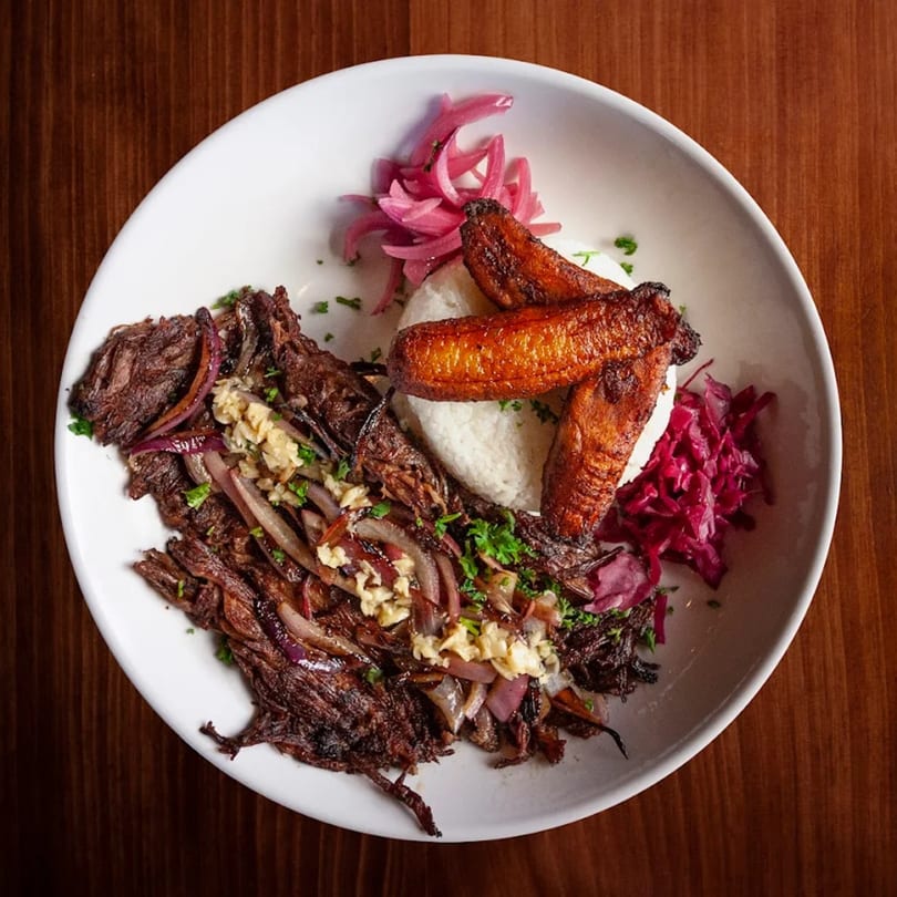 Baracoa Cuban Restaurant's Ropa Vieja with rice, fried plantains, pickled red onions, and cabbage.